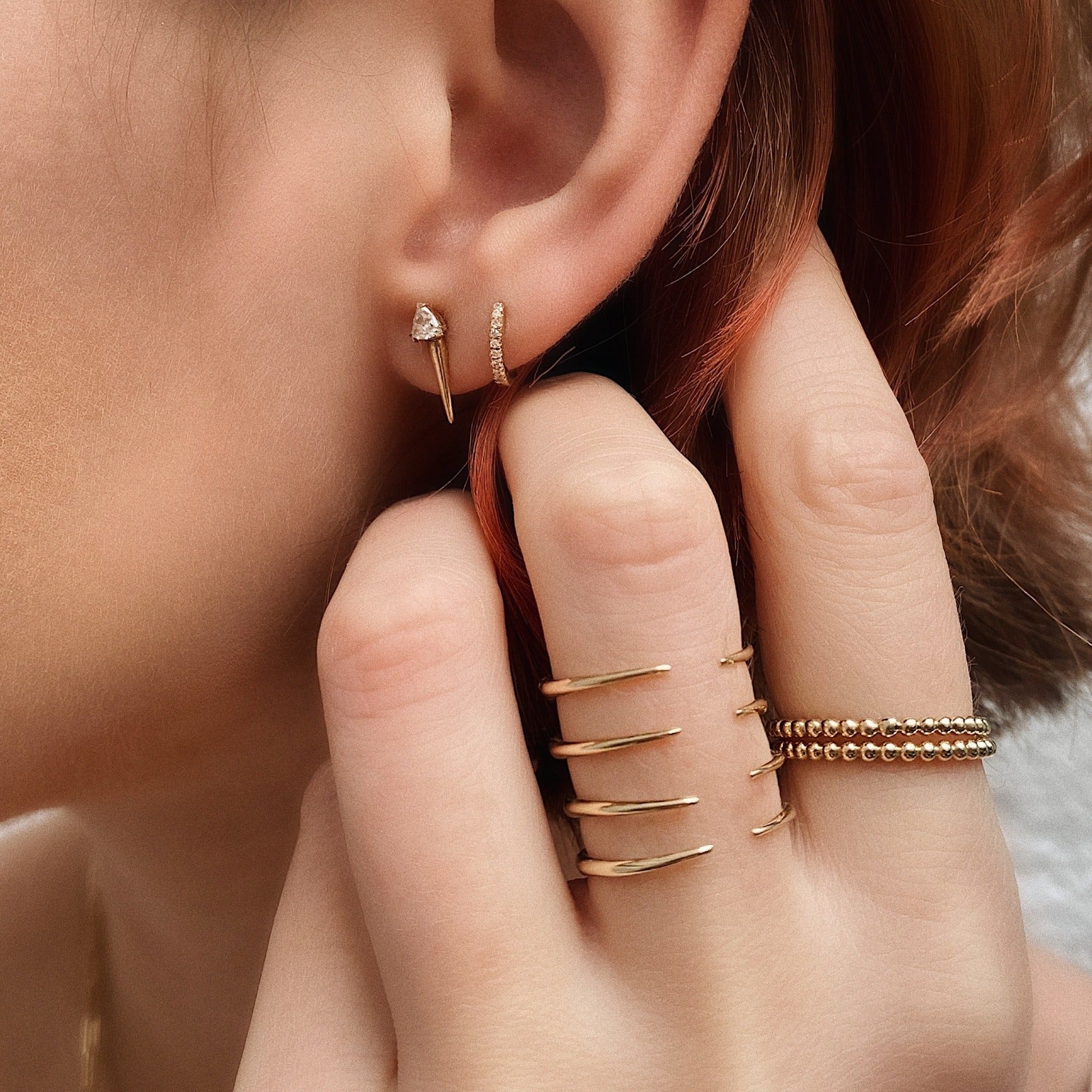 14k gold bead rings styled on a hand