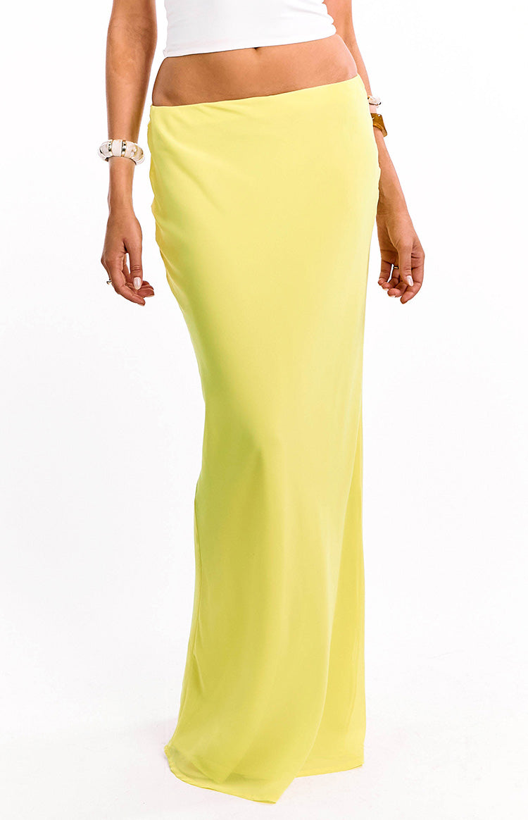 Full length front view of a sheer yellow fitted maxi skirt with a floor-length hem, resort