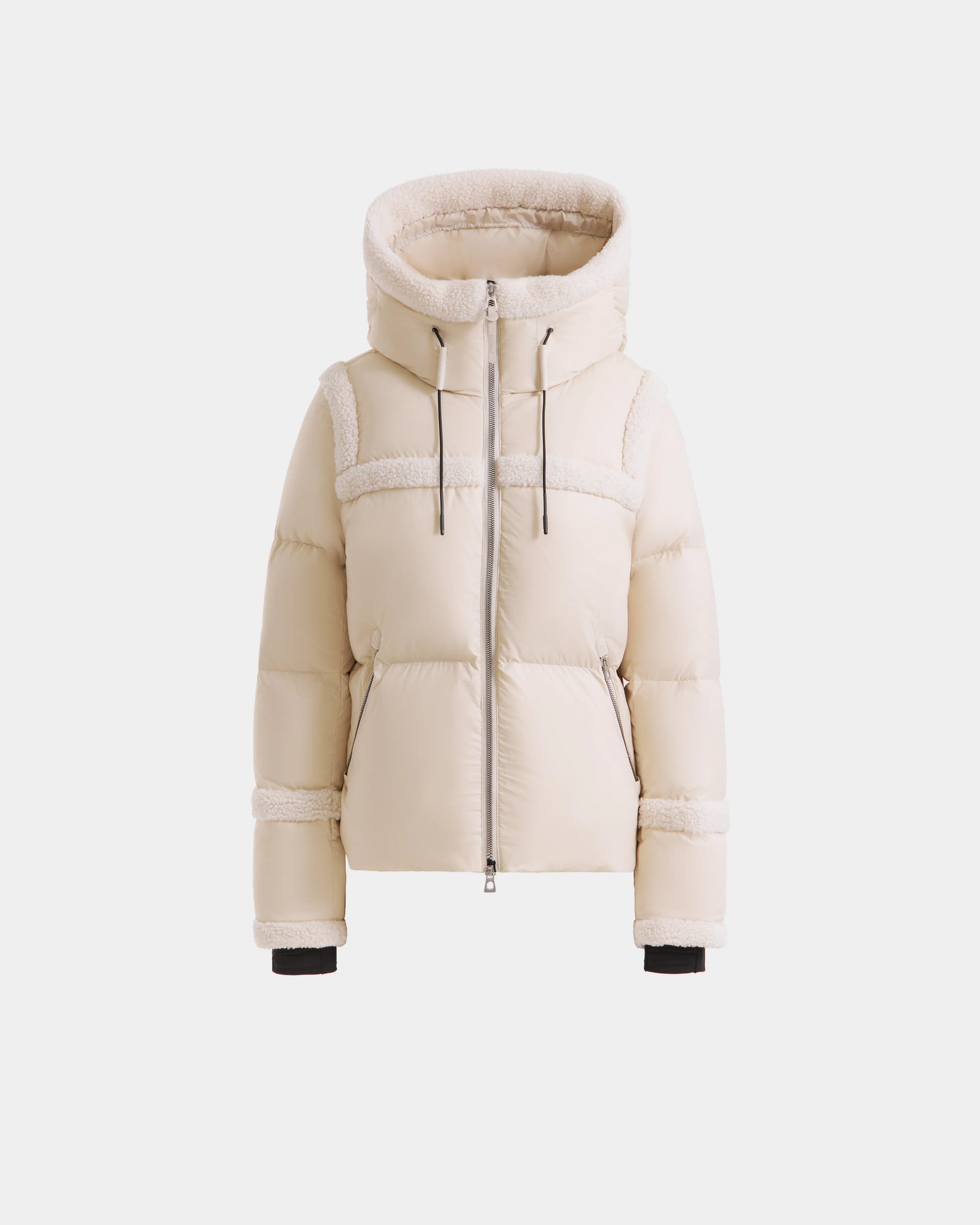 The JULIANA - L124509 Vanilla by Rudsak is a cream women’s short down puffer with a large hood, front zipper, and drawstrings. Soft textured accents on the seams and cuffs lend a cozy, stylish touch for winter.