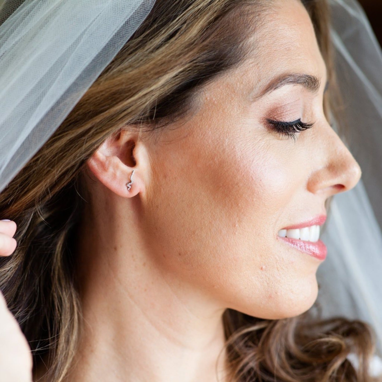 14K recycled gold Full Pavé Small Ripple Climber Earring styled on an ear of a bride with a vale