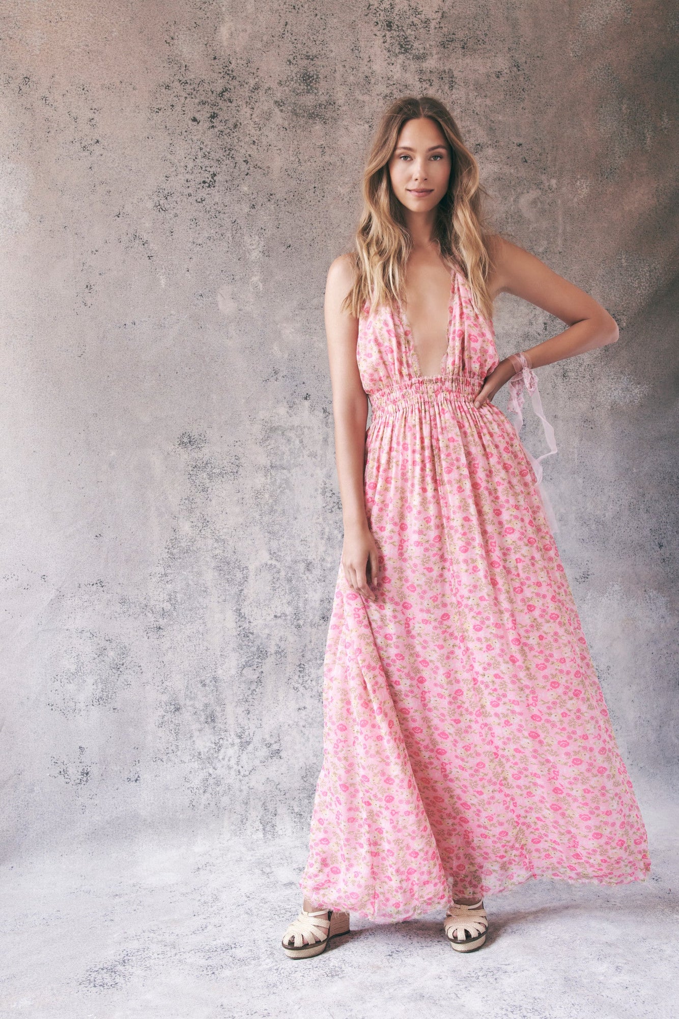 Model wearing pink floral halter maxi dress