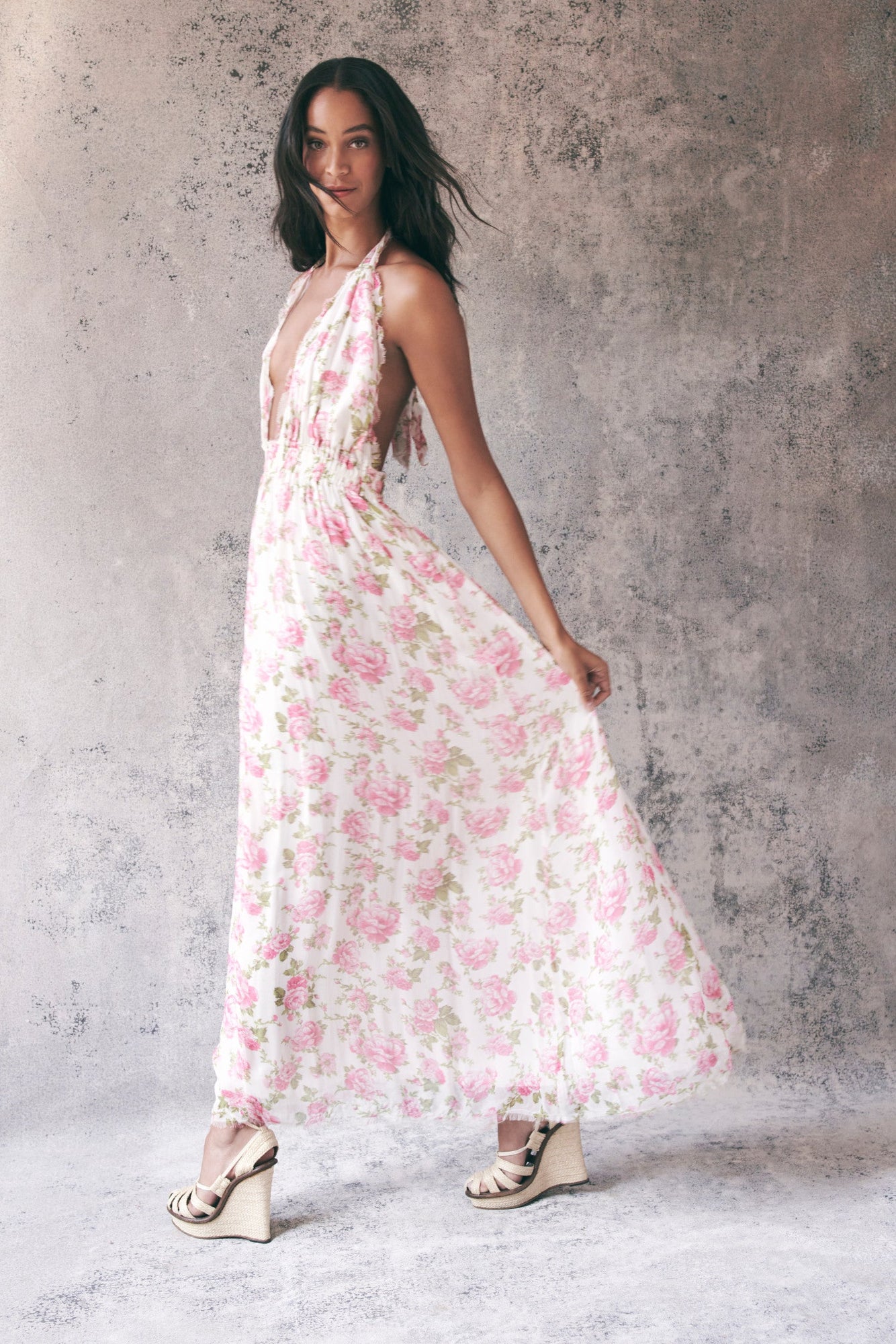 Model wearing pink floral halter maxi dress