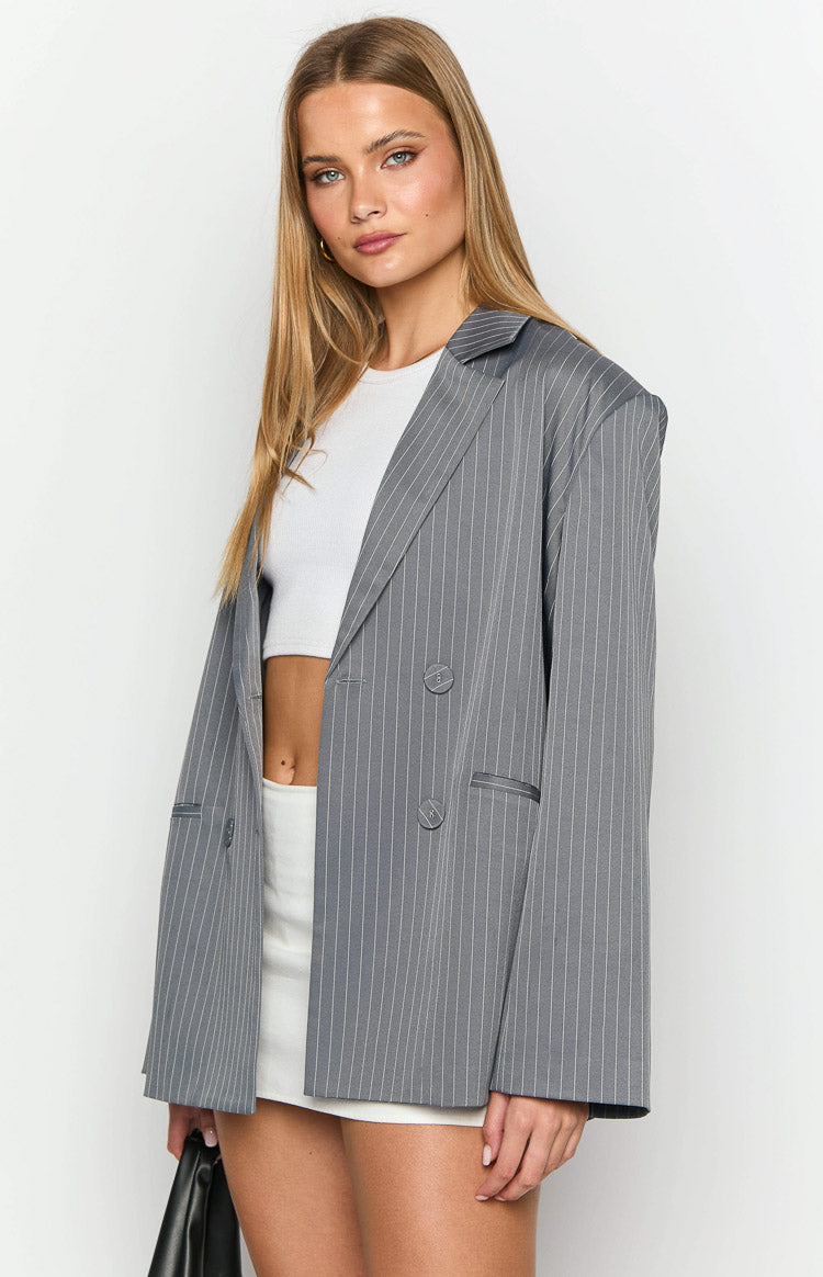 Grey pinstripe oversized blazer with notched lapels and double-breasted front, worn open