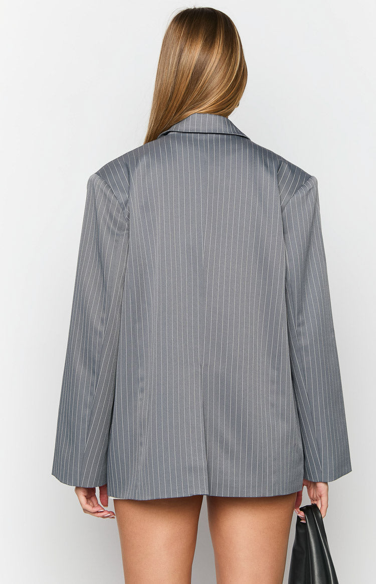 Rear view of an oversized grey pinstripe blazer with a structured collar
