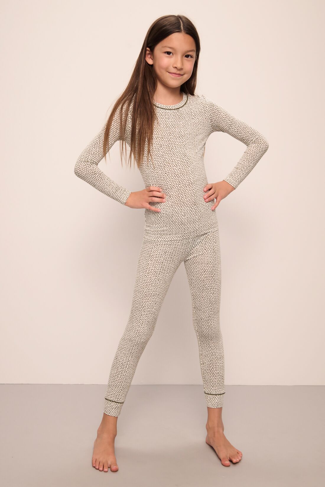 Model wears Kids Printed TENCELâ„¢ Modal Unisex Long PJ Set in Ella Spark/Moss.