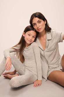 Model wears Kids Printed TENCELâ„¢ Modal Unisex Long PJ Set in Ella Spark/Moss.
