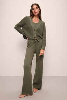 Model wears Recycled Sweater Pant in Moss.