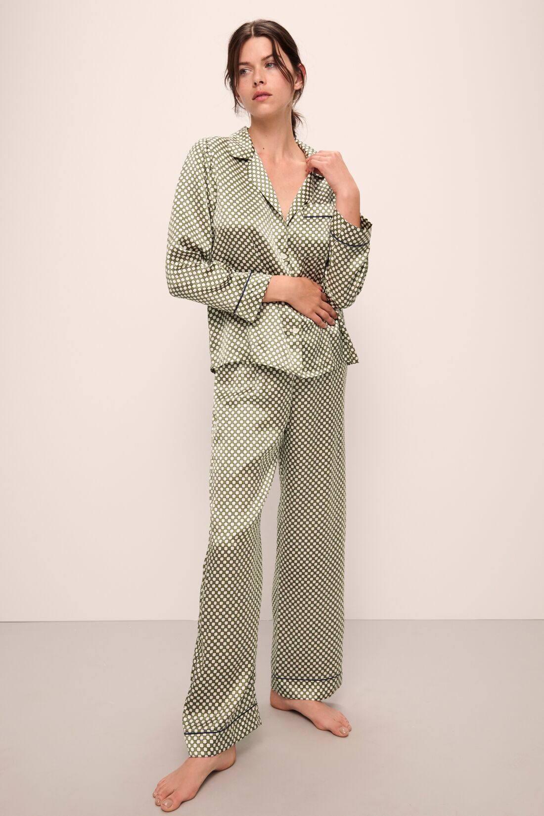 Model is wearing Inez Washable Silk Printed Long PJ Set in Geo Sphere Moss/Navy.