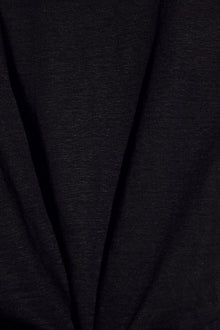 Model wears Organic Linen Knit Short Sleeve T-Shirt in Black.