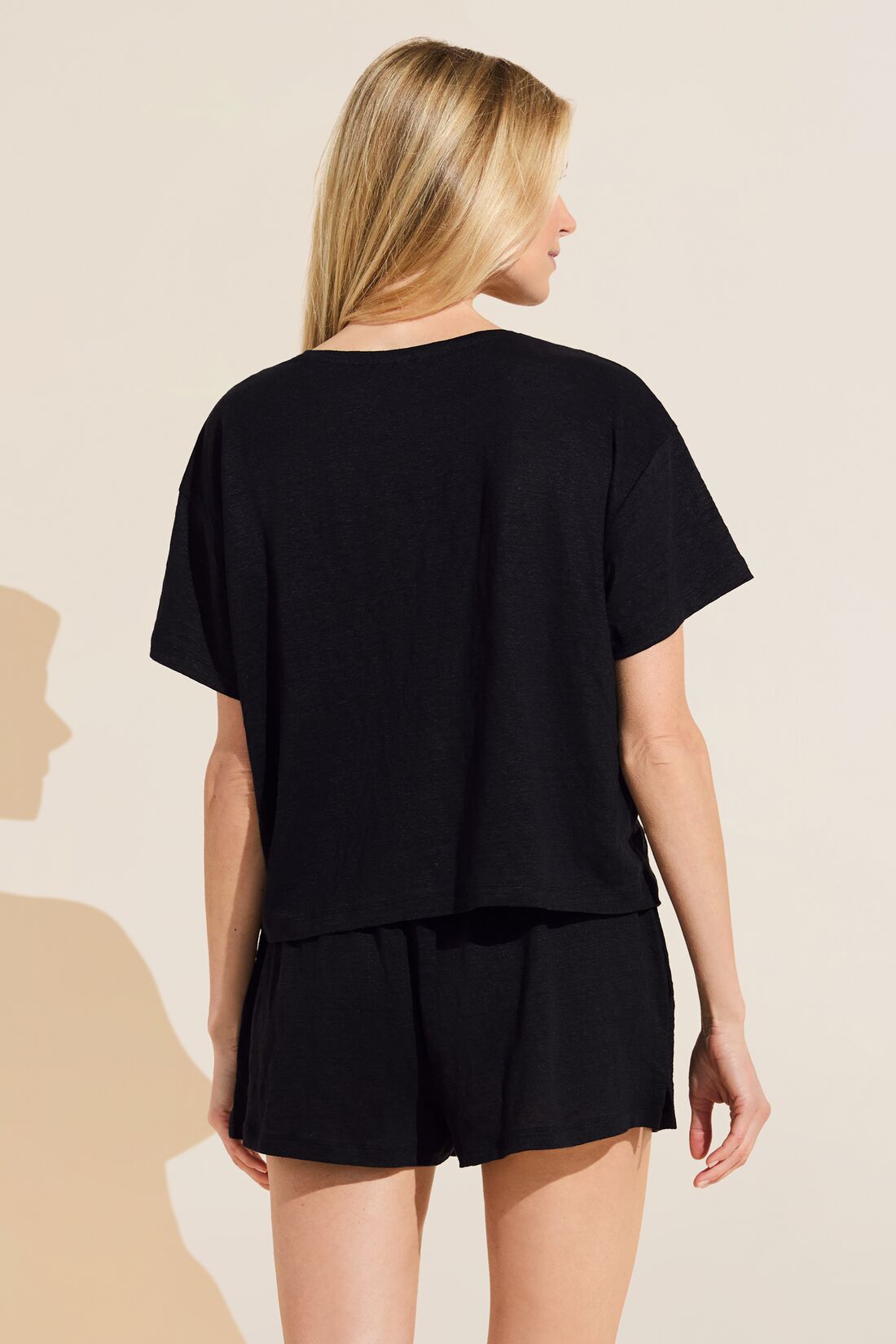 Model wears Organic Linen Knit Short Sleeve T-Shirt in Black.