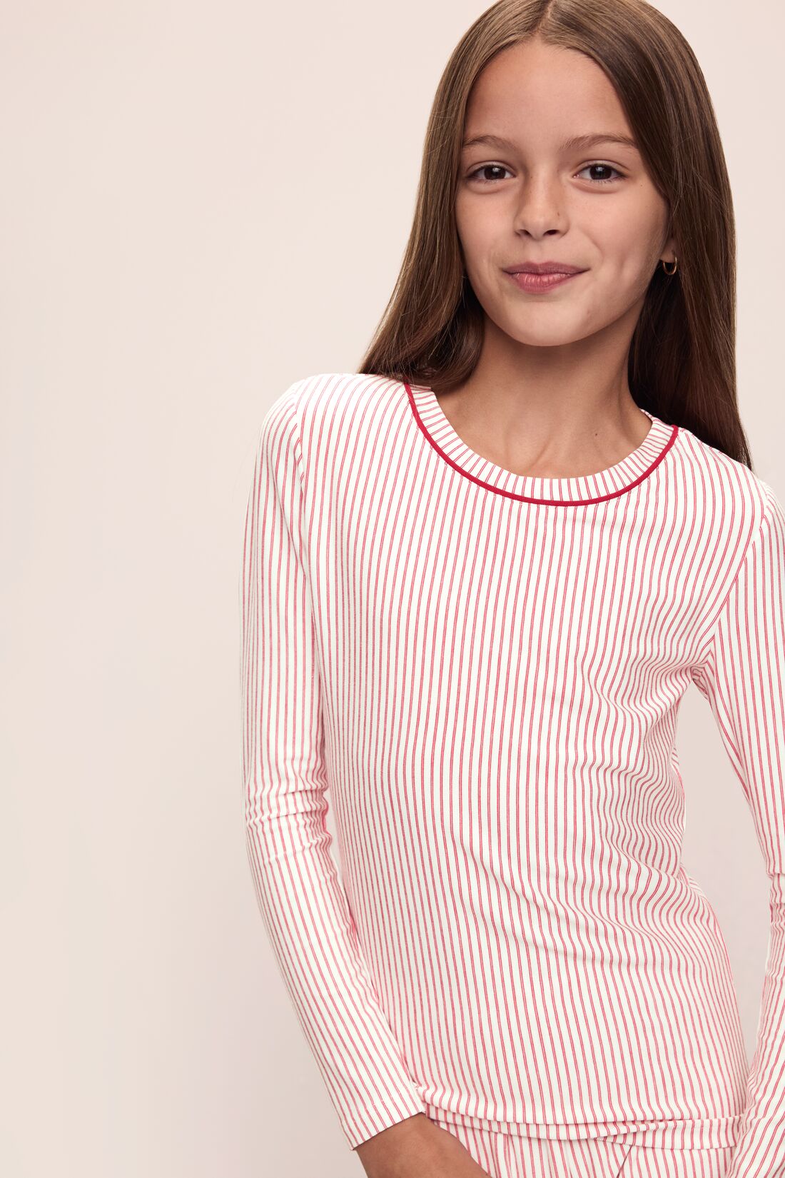 Model wears Kids Printed TENCEL Modal Unisex Long PJ Set in Duo Stripe Haute Red/Haute Red.