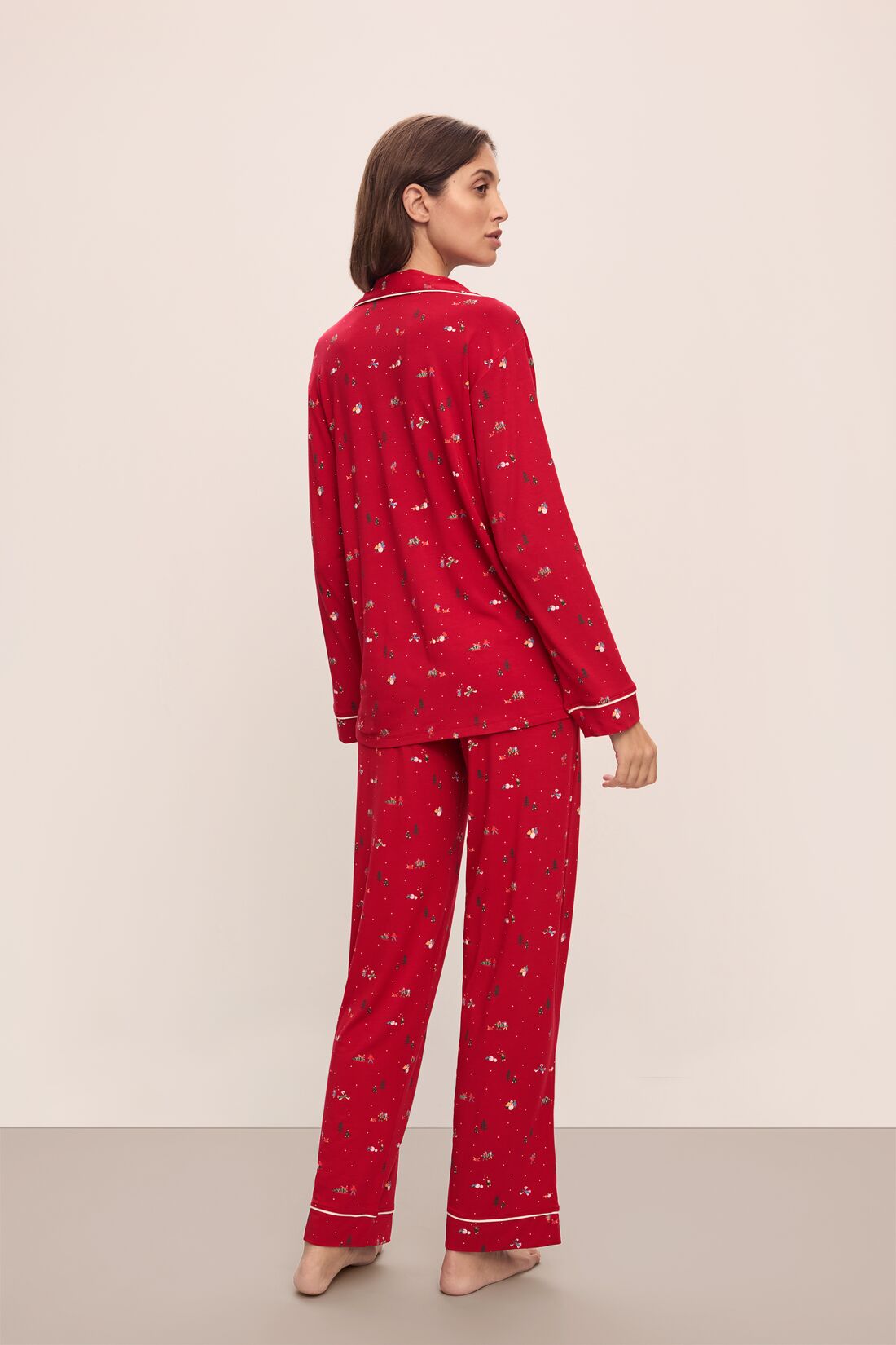 Model wears the Gisele Printed TENCEL Modal Long PJ Set in Winter Wonderland Haute Red/Ivoryory.