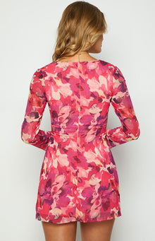 Detail shot of the ruched bodice and side tie on the pink floral print dress