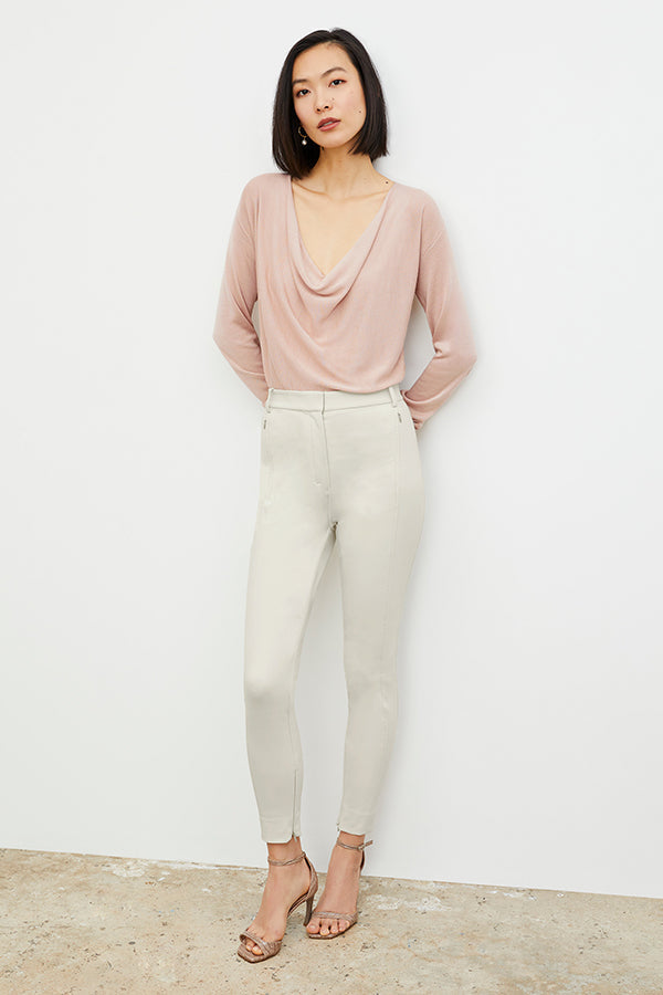 Front image of a woman standing wearing the Curie Pant—Everstretch in Bone | Exclude | Grid