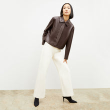 Front image of a woman wearing the nicky jacket in brown