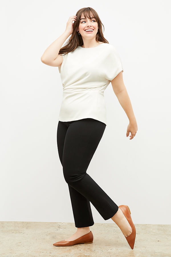 Front image of a woman standing wearing the Foster Pant—Everstretch in Black | Exclude