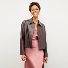 Front image of a woman wearing the nicky jacket in brown