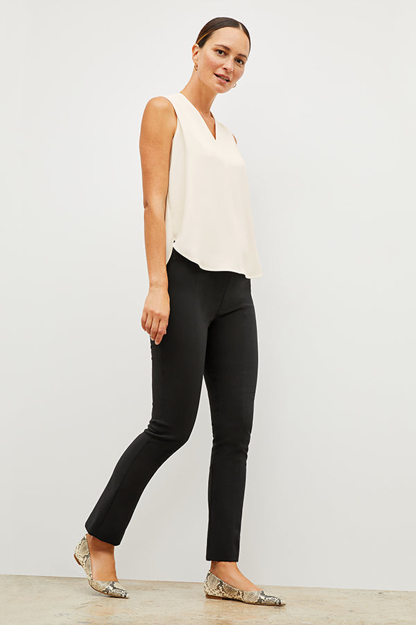 Front image of a woman standing wearing the Foster Pant—Everstretch in Black | Exclude