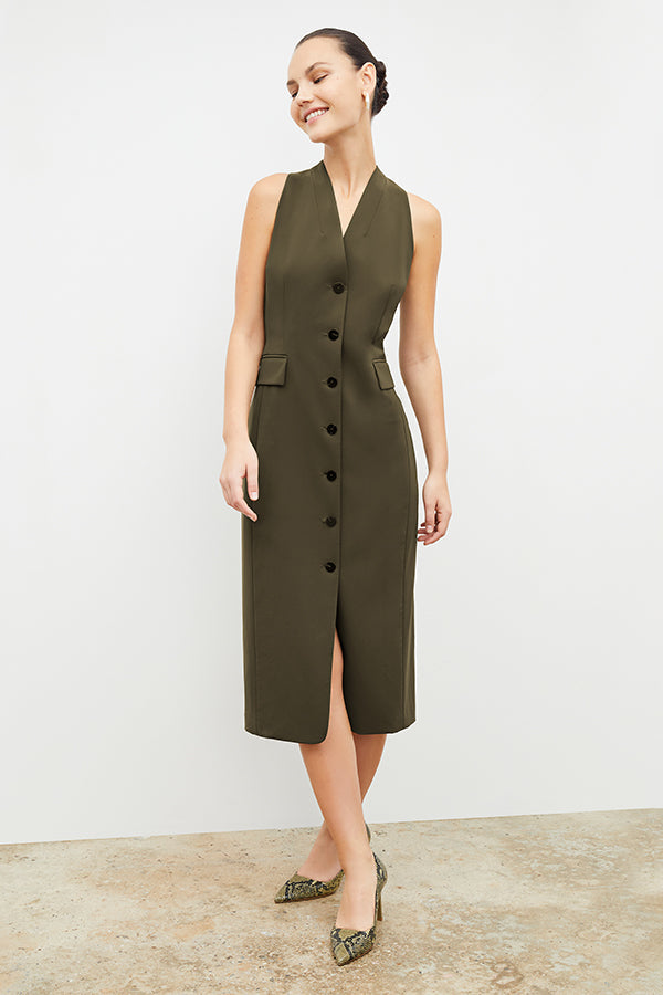 Front image of a woman wearing the Cassandra dress in origamitech in olive | Exclude | Grid