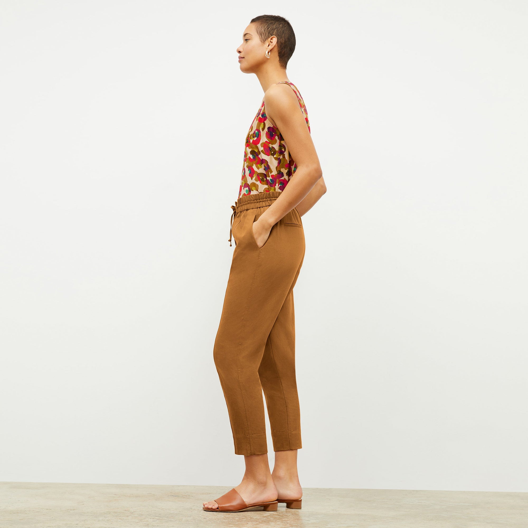 Side image of a woman wearing the Shane Pant in Acorn | Exclude
