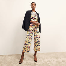 front image of a woman wearing the madelyn pant in savannah print