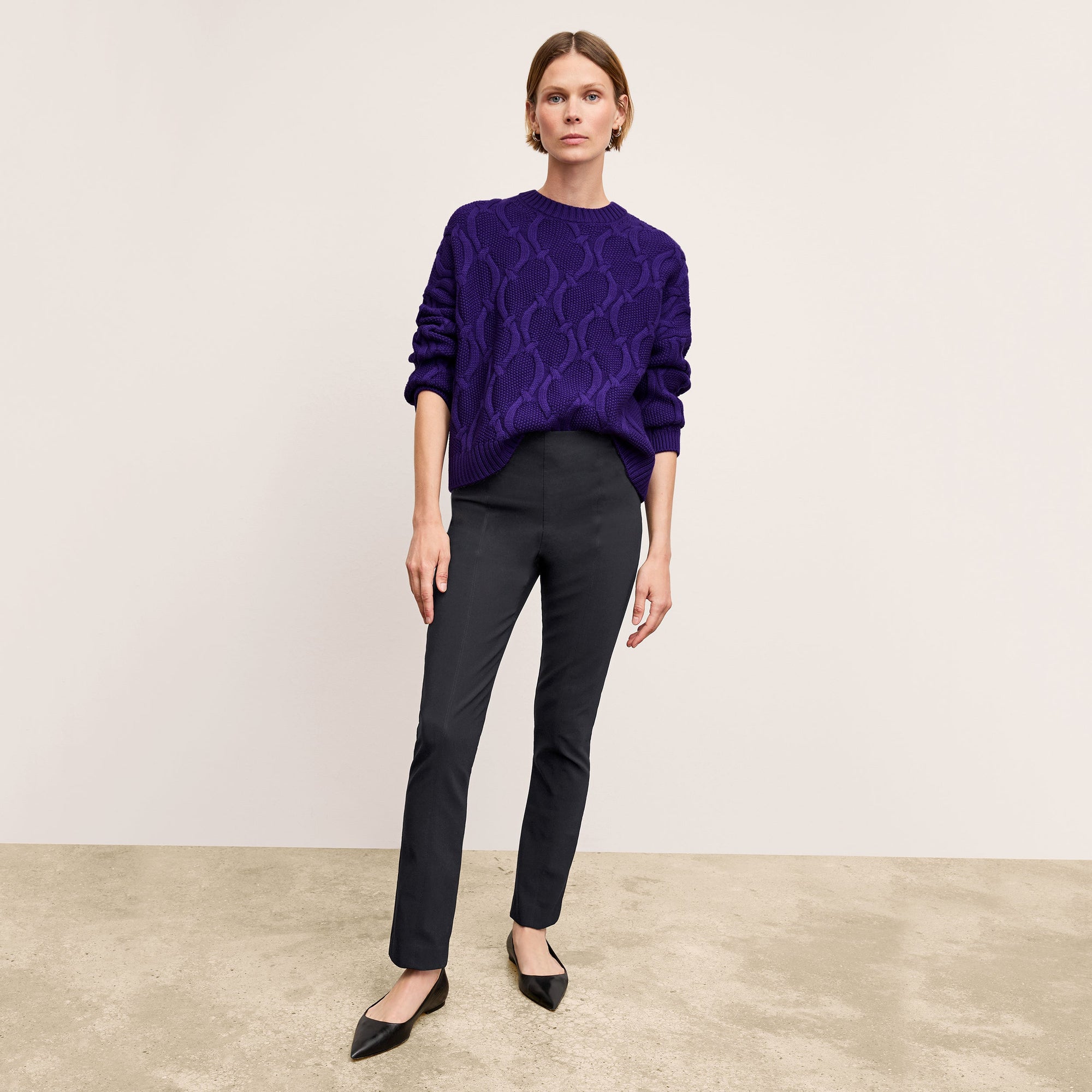 Front image of a woman standing wearing the Foster Pant—Everstretch in Black | Exclude