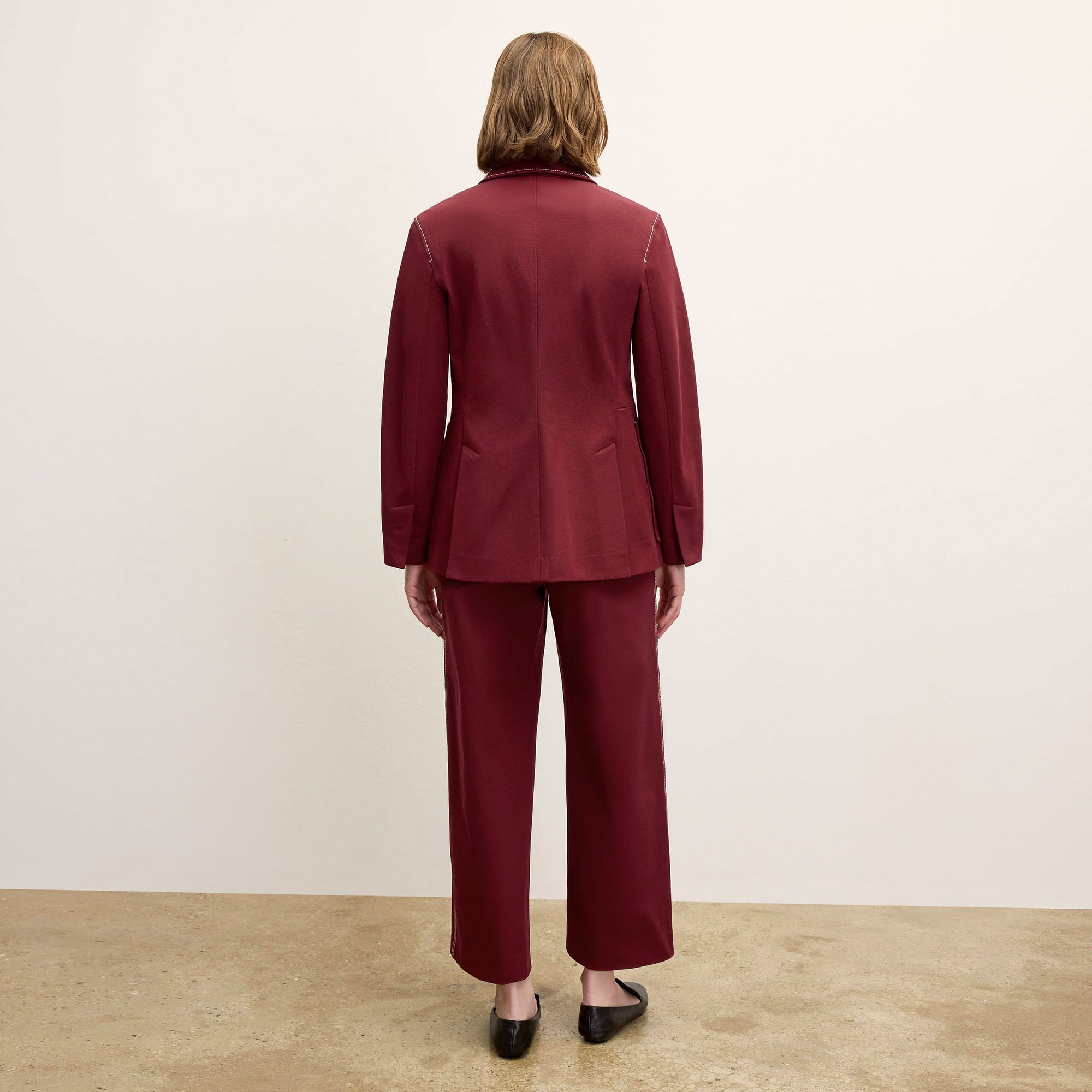 back image of a woman wearing the abby pant in berry jam 