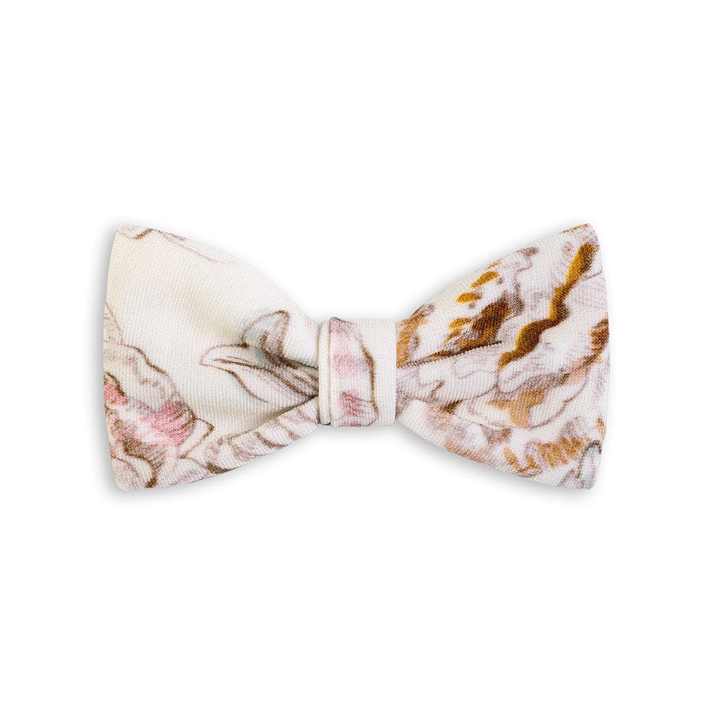 Small cream-colored bow clip with pink, brown, and gold floral pattern throughout.