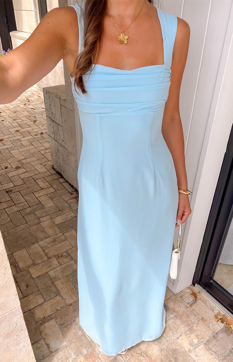 Front view of a light blue maxi dress with a ruched square neckline, wide straps, and a fitted bodice with seams