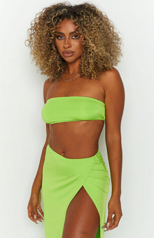 Close-up of a lime green strapless bandeau top with a smooth, fitted silhouette