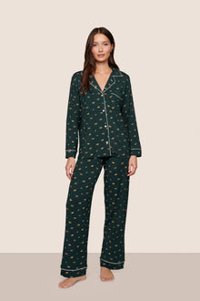 Model is wearing Gisele Printed TENCEL Modal Long PJ Set  in Holiday Dogs Pine/Ivory