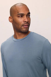 Model is wearing Henry TENCEL Modal Long Sleeve Crew PJ Set in Faded Denim
