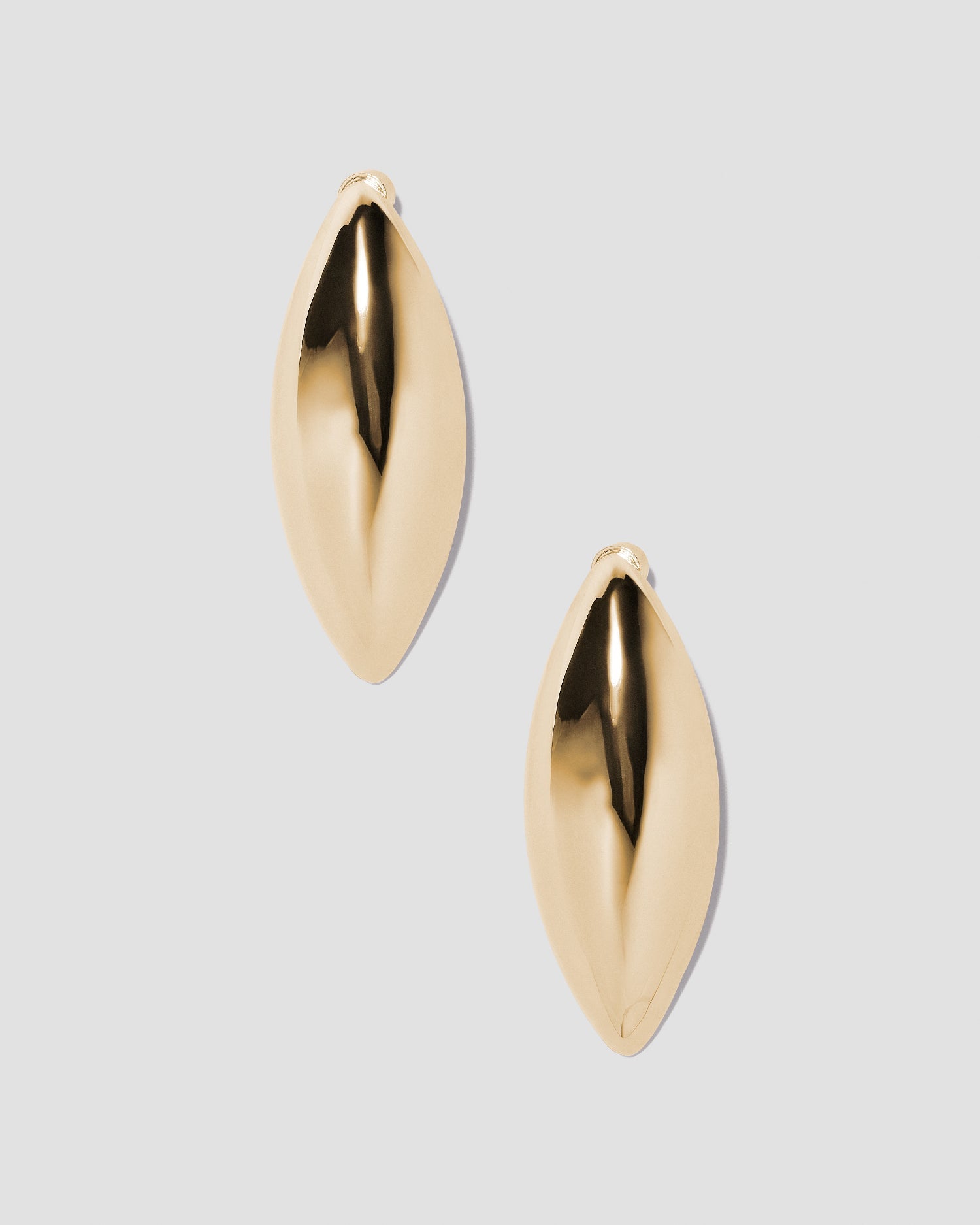 Puffy Dagger earrings on grey background. 