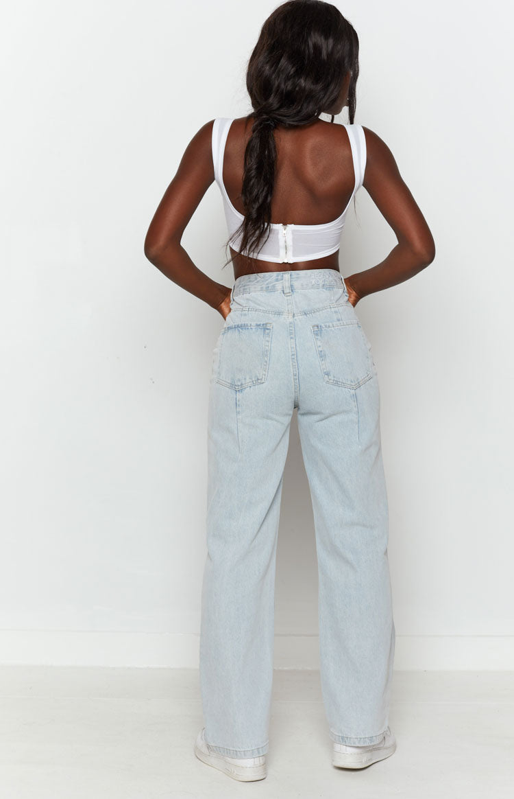 High-waisted light blue wide leg jeans with back pockets and a prominent vertical seam down each leg