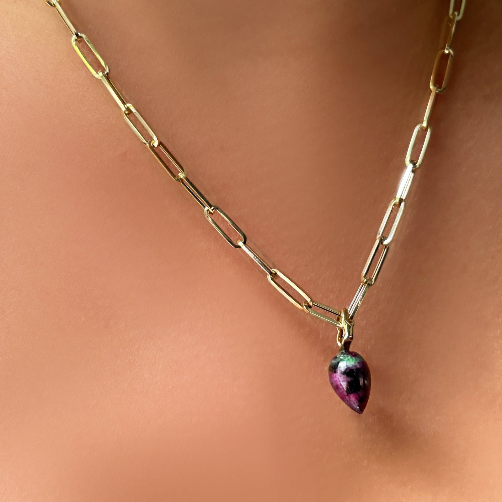 Ruby Zoisite Drop Charm and chunky paperclip chain necklace on the neck.