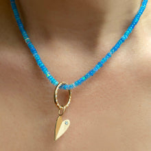 14K Gold Folded Heart Charm with white diamond styled on neck with opal necklace and charm lock