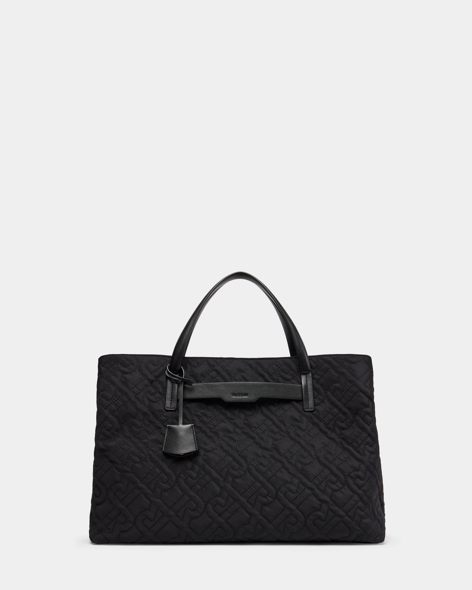 The Rudsak ASMINE - L325005 Black tote features two top handles, a subtle embossed pattern, and a hanging tag, shown against a light gray background—an elegant work bag for any professional setting.