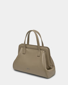 A close-up of the Rudsak TAULLA - 8325002 Almond women’s pebble leather satchel, featuring a removable shoulder strap and a spacious interior.