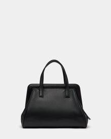 The Rudsak TAULLA - 8325002 Black women’s pebble leather satchel features two top handles, a structured rectangular silhouette with softly rounded sides, and a spacious interior, shown against a light gray background.