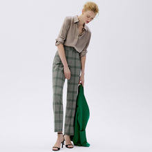 front image of a woman wearing the smith pant in check plaid