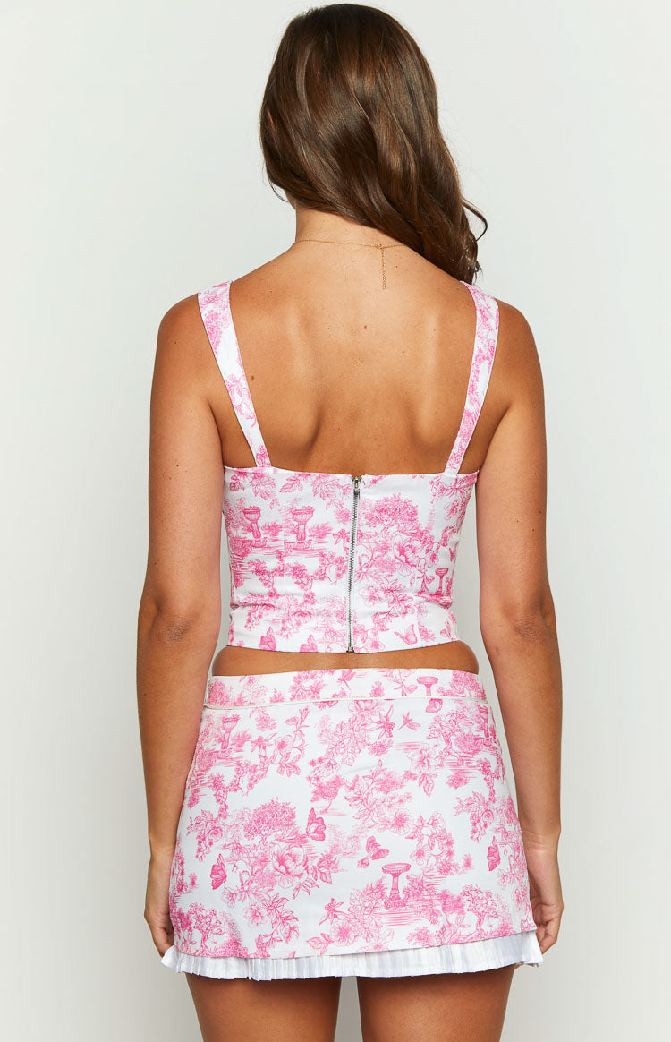 Rear view of the pink and white floral print crop top with a silver zipper closure down the center back