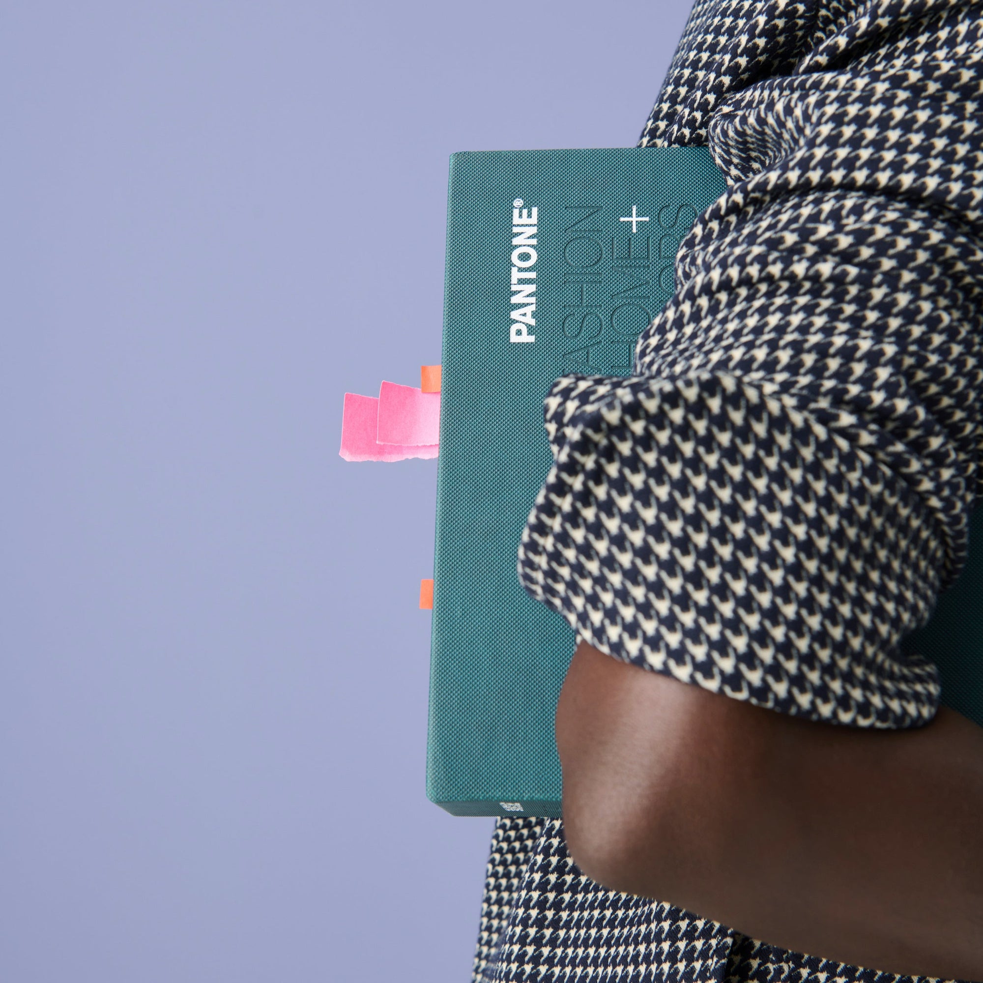 Image of a woman in the Tully Top in Houndstooth holding a pantone book under her arm