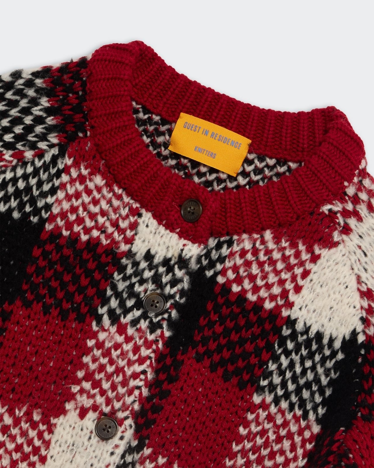 Buffalo Plaid Cardigan Ruby Combo close-up of buttoned chunky knit with red black and white patterns and ribbed collar