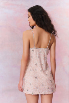 Mini dress with tiny, intricate beads that make up larger rhinestone-studded flowers. Features rhinestone spaghetti straps and a rhinestone-lined neckline. The dress has a slim, figure-hugging silhouette.