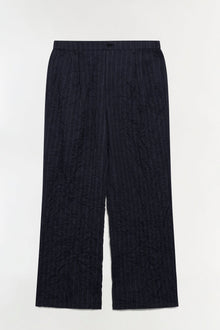 Navy pinstriped double pleat pants with elastic waistband and wide-leg silhouette.