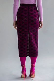 Slim-fitting fuchsia aubergine pencil skirt with a subtle pattern and front slit, styled to show a smooth, streamlined look when worn as intended.