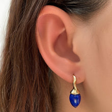 Lapis drop earrings with yellow gold and diamond ripple bales, on the ear.