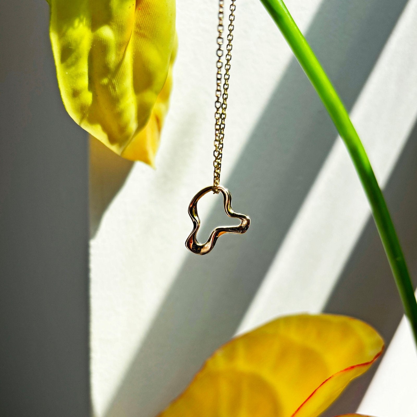 14k recycled gold Plain Ripple Charm styled on a Diamond Cut Cable chain 