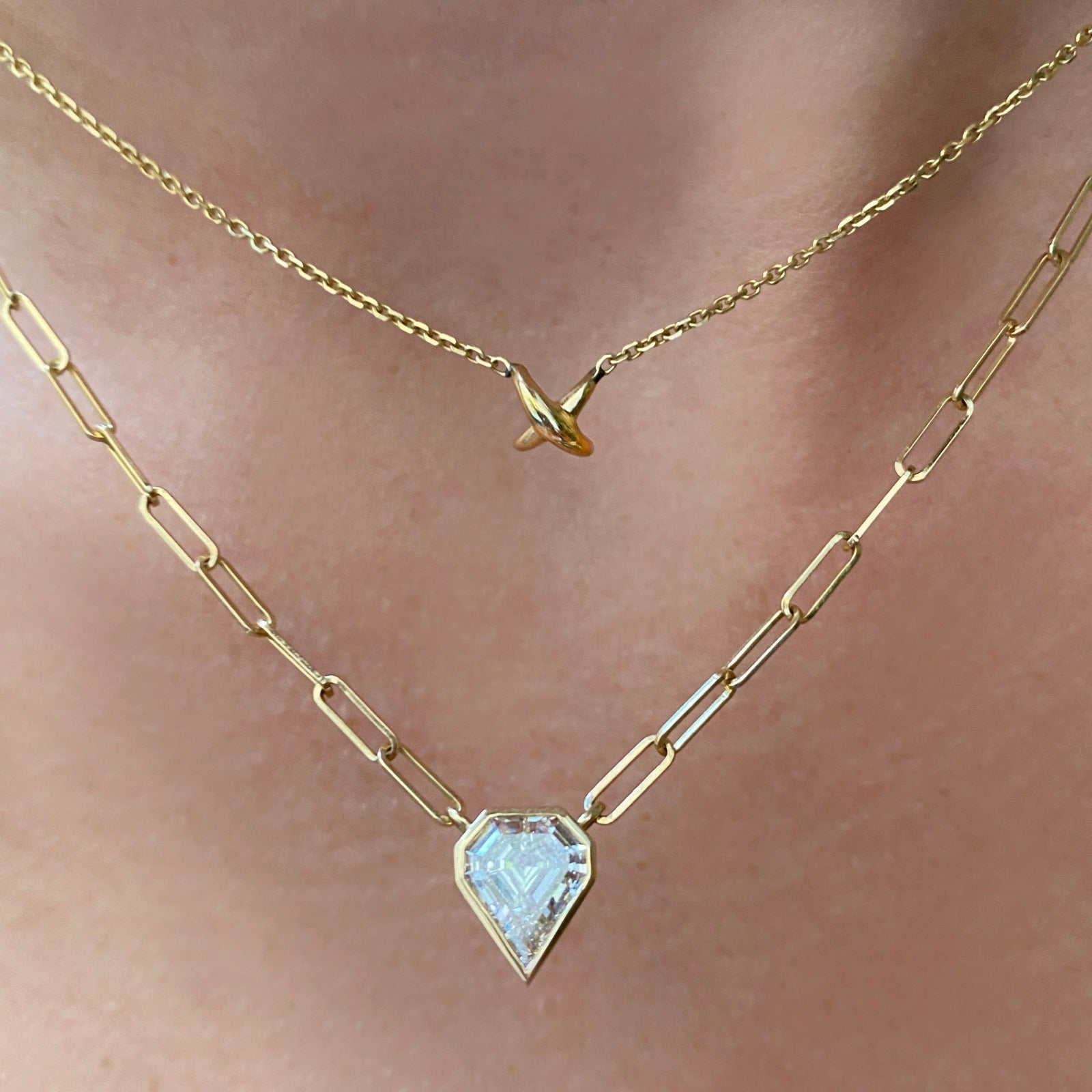 14K Recycled Gold Stitch chain necklace styled on a neck with various chains