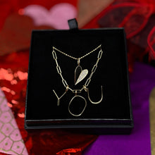 Folded Heart Charm in yellow gold with half diamond pavé on a bead chain styled in a gift box